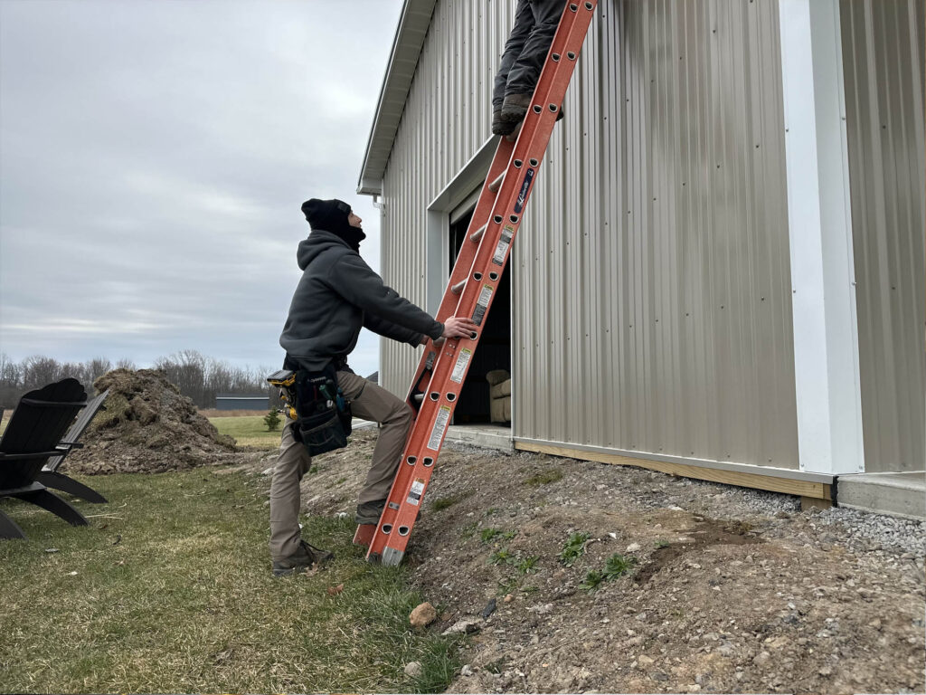 Footing ladder while hanging outside light
